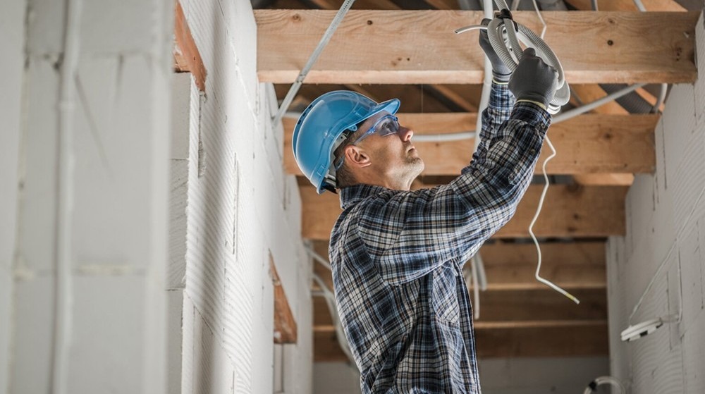Commercial electrician working with cables.