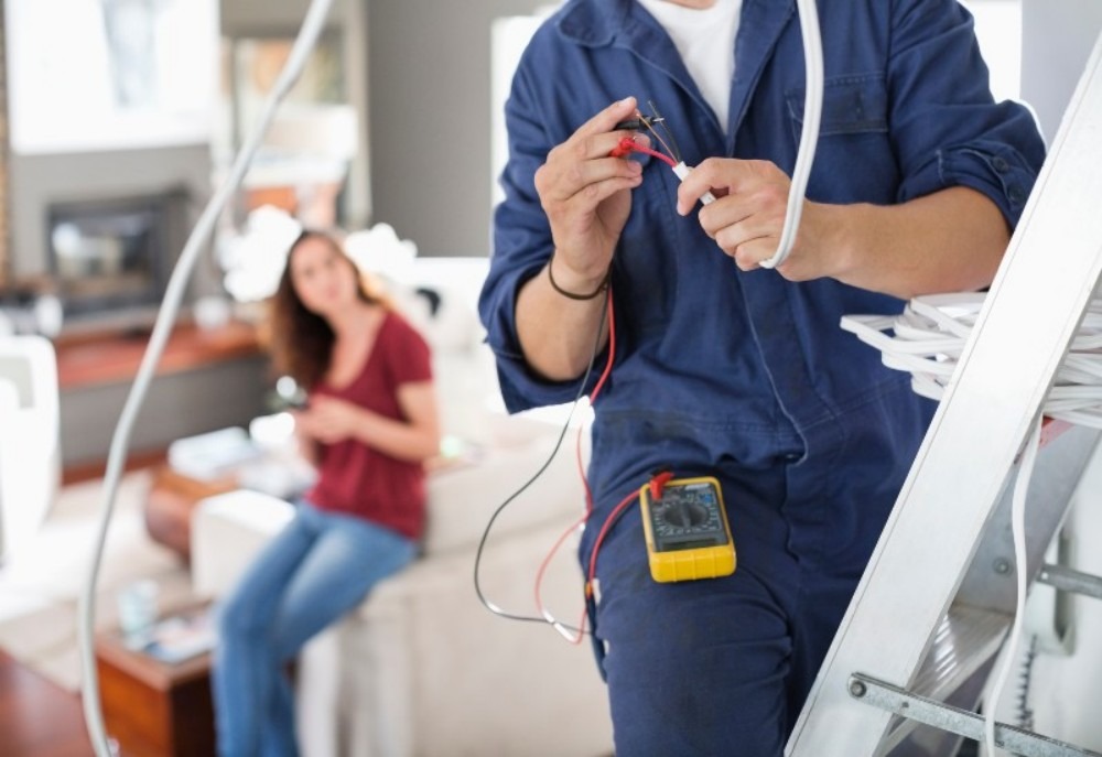 An electrician working in a home.