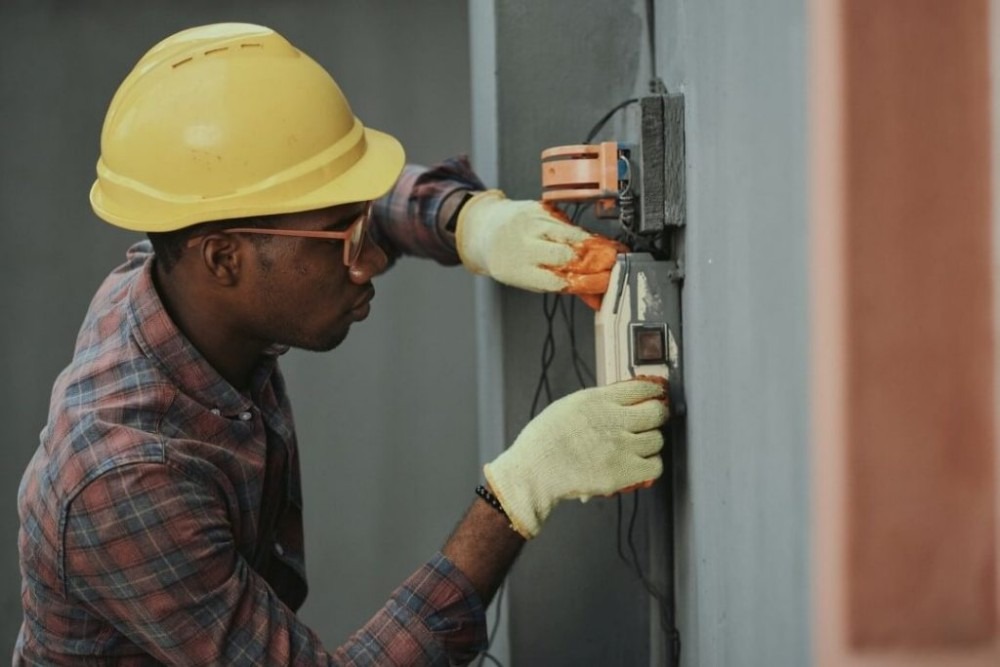 Electrician working on the installation of a switch.